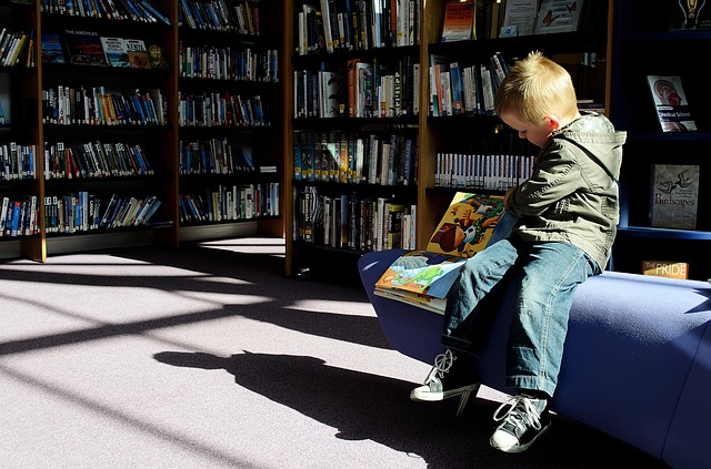 kid reading at library